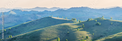 Panoramic view of the summer evening, hills and mountain slopes in sunset light