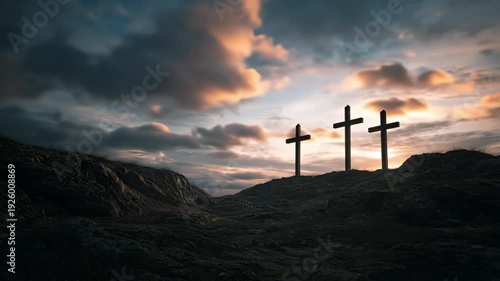 Three wooden crosses on the rocky Mount Calvary under a dramatic timelapse sky with sunlight breaking through clouds. Concept of faith, crucifixion and catholicism