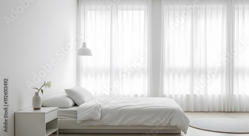 Serene white bedroom with bed, nightstand, and sheer curtains, illuminated by soft natural light pouring in through large windows