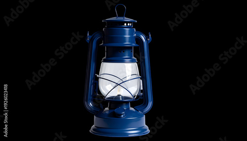 Dark blue kerosene lantern with clear glass globe isolated on black backdrop; vintage style camping light for atmospheric illumination