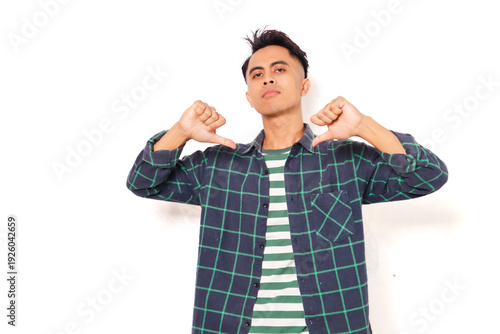 Arrogant young Asian man standing and pointing at himself with a proud expression on white background. Self-confident and ego concept