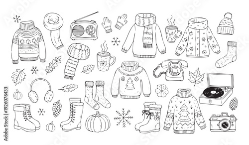 Cozy winter and autumn warm clothing with various seasonal accessories like sweaters, scarves, boots, mugs, and entertainment items for comfortable seasonal living concepts