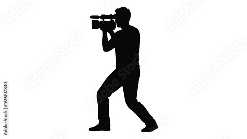 Silhouette of a person operating a professional video camera high quality