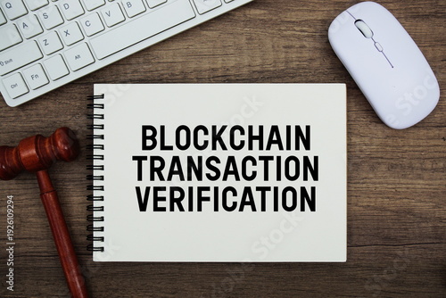 Photos Blockchain Transaction Verification text written with gavel, keyboard and optica