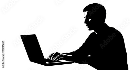 Silhouette of a man working on a laptop computer