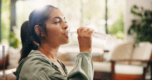 Bild auf Leinwand Thirsty, woman and drinking water in lounge with bottle, wellness and natural detox for gut health