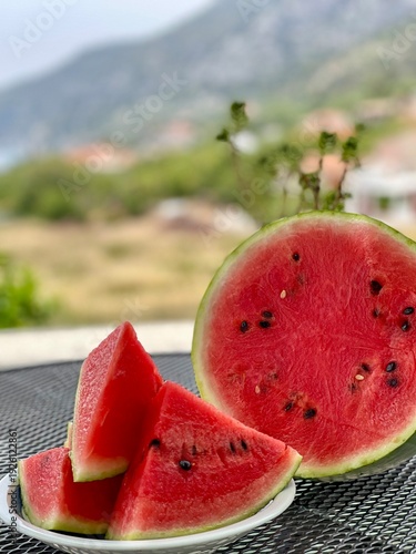 A delicious meal in Croatia. Dalmatian restaurant. Pizza, salad, and fruit. Watermelon on the table.