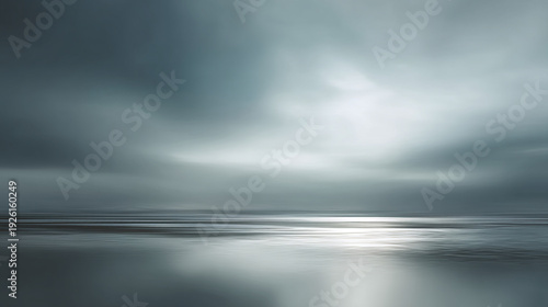 Dreamy Moody Beach Landscape with Reflective Water and Clouds