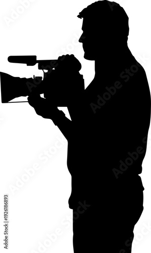 Silhouette of a man operating a video camera
