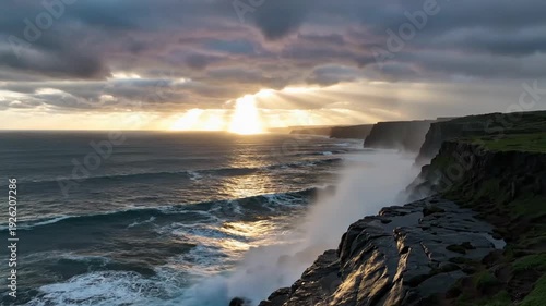 Dramatic ocean view with waves crashing against a cliff at sunset, with golden light rays