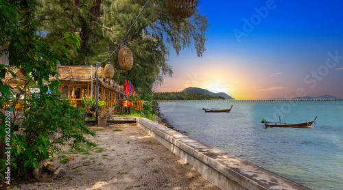 Colourful Skies Sunset over Rawai Beach in Phuket island Thailand. Lovely turquoise blue waters, lush green mountains colourful skies and beautiful views of Pa Tong Patong