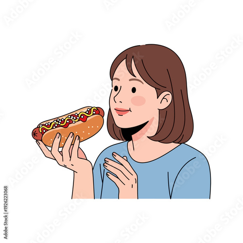 Woman holding a loaded hot dog with ketchup and mustard, enjoying a snack
