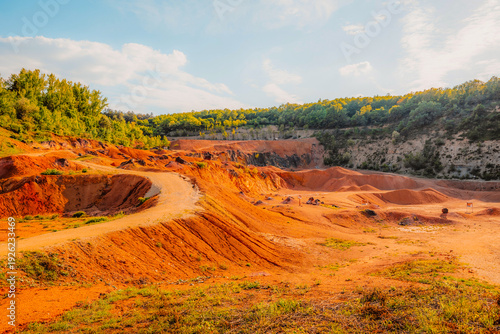 Tableau sur toile Gant, Hungary, view of the terraces of an old bauxite mine and bauxite formation with red and orange surface