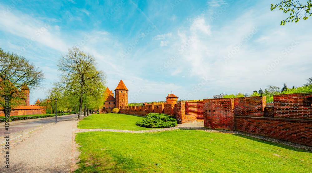 Fototapeta premium Teutonic Malbork castle in Pomerania region with Nogat river in Poland