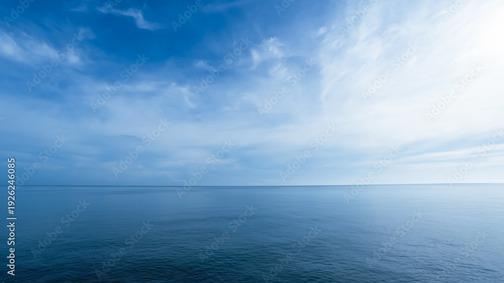 Fototapeta premium Sky,sea blue ocean background,Horizon beach,water sea ,clear sky,cloud in sunny day.Calm sunrise of soft morning light for summer backdrop,Afternoon sky environment with abstract texture of cloudy