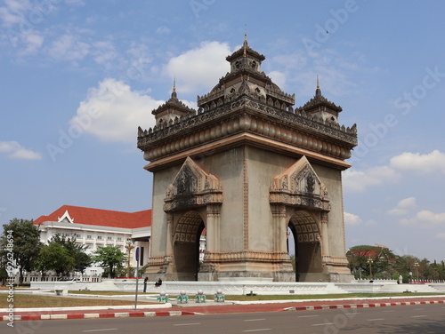Photography VIENTIANE, LAOS - FEBRUARY 25, 2026: The iconic Patuxay Victory Gate monument under a blue sky with tourists visiting