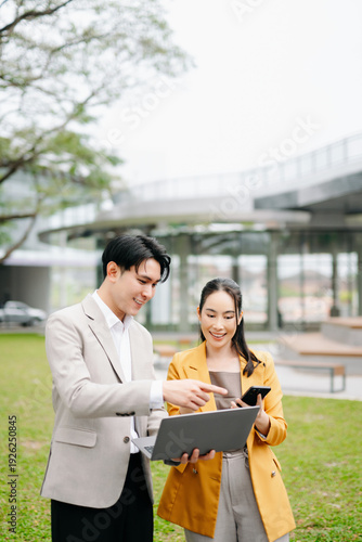 Asian business team discussing strategy and planning outdoors, corporate meeting, teamwork, leadership and professional collaboration