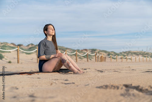 Wallpaper Mural Woman meditating on beach enjoying mindfulness and wellness Torontodigital.ca