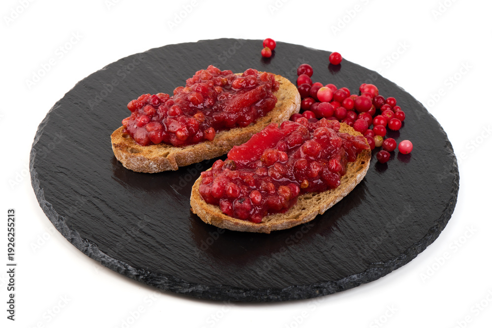 Obraz premium Lingonberry Toast on Black Slate, isolated on white background