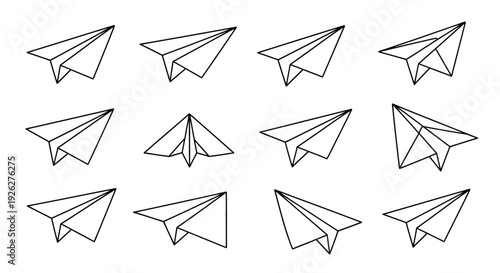 A collection of paper airplanes flies through the air in various directions.
