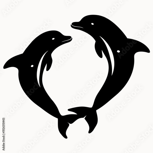 Two dolphins forming heart shape with bodies in ocean