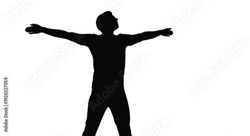 Silhouette of a young man celebrating with arms outstretched in a triumphant gesture
