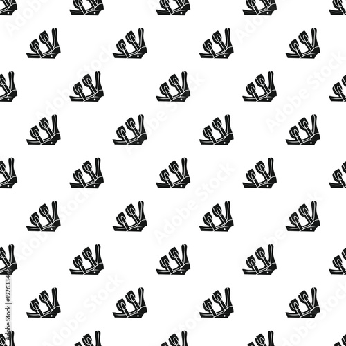 Snowboard bindings creating a repeating black and white winter sport equipment design