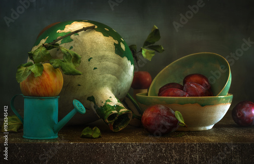 Still life with ripe and delicious plums, an apple and an old ceramic jug.