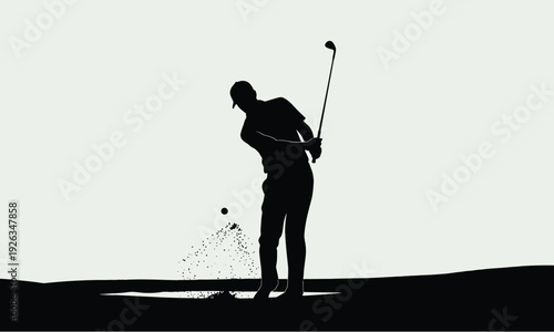 Silhouette of male golfer hitting ball from sand bunker on a course
