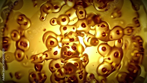 Molecular cell golden color. Moving cell are merging or breaking. Close-up photo or view through microscope. Abstract background for about medical and scientific. Animation Seamless loop, 3D Render.