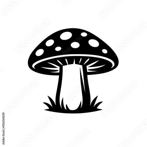 Stylized black and white vector illustration of a classic toadstool mushroom featuring a distinctive spotted cap and visible gills, artfully rooted in a small patch of grass. An ideal icon for fantasy