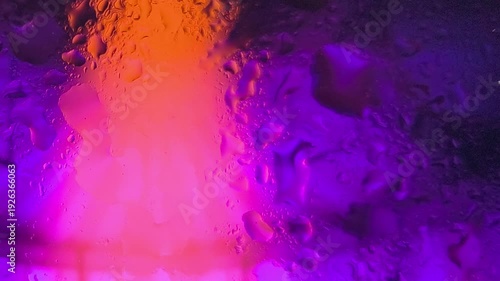 Close-up of a vibrant, textured surface with a warm orange and cool purple gradient lighting effect.