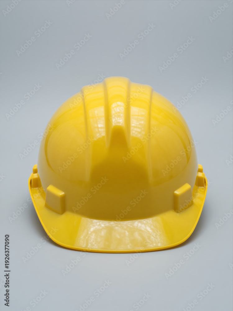 Fototapeta premium Yellow Hard Hat Isolated On Gray Background, Safety Construction Helmet, Front View
