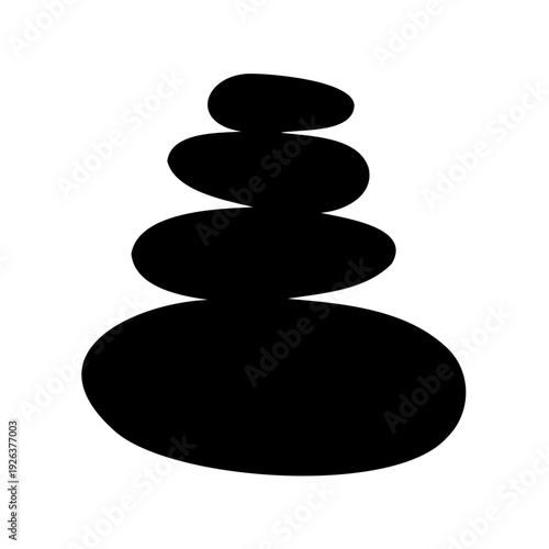 Silhouette of stacked smooth rocks in balance forming a zen tower