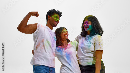 Fotografie Young Indian friends celebrating Holi with joy isolated on white
