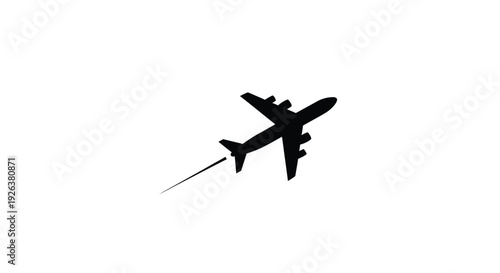 A dark airplane flies across a bright background silhouette