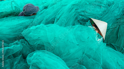 Fotografie Mending Fishing Nets in Phu Yen Coastal Village
