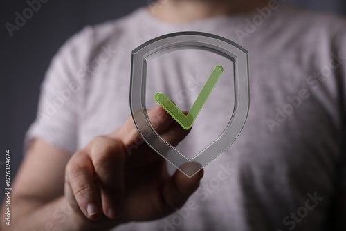 Hand touching a shield with...