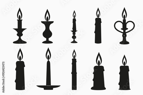 A collection of black silhouette candles in varying shapes and sizes