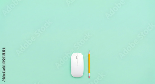 White computer mouse and yellow pencil on mint green background, flat lay desktop workspace