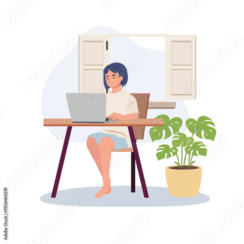 Work From Home Concept Female Freelancer Using Laptop at Desk with Indoor Plant