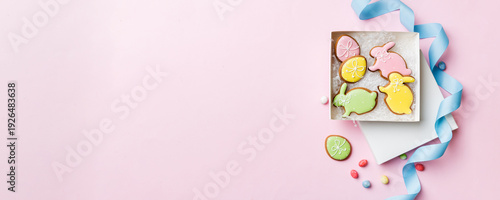 Wallpaper Mural Colorful easter cookies in basket with Multi colors Easter eggs on colored background . Pastel color Easter eggs. holiday concept with copy space Torontodigital.ca