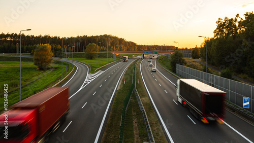 Highway near Brzesko at sunset with blurred trucks in motion | Autostrada w okolicach Brzeska o zachodzie słońca z rozmytymi jadącymi ciężarówkami