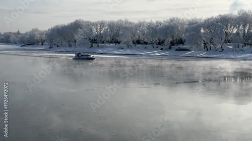 A rescue hovercraft navigates a frozen river
