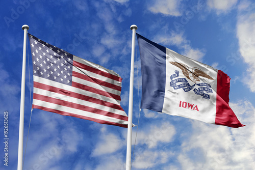 Fotografie United States and Iowa State Flags Waving in Unison Against a Blue Sky Represent