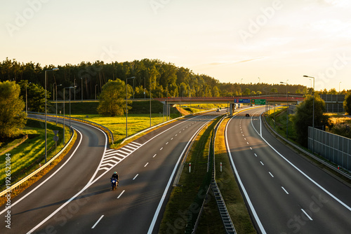 The highway near Brzesko at sunset with motorcyclist on the road | Autostrada w pobliżu Brzeska z motocyklistą na drodze, o zachodzie słońca