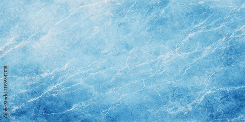 A fresh abstract nature background featuring the cool blue water surface and frozen ice textures of a shimmering summer sea under a bright winter sky