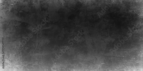 Abstract black and white grunge background featuring a dark textured stone wall with an old vintage concrete pattern and a dirty grey paper surface design
