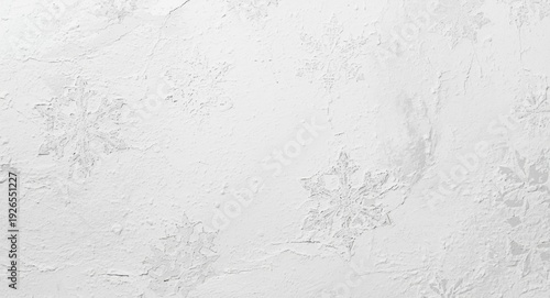 Smooth plaster wall closeup featuring white paint texture with snowflake like designs