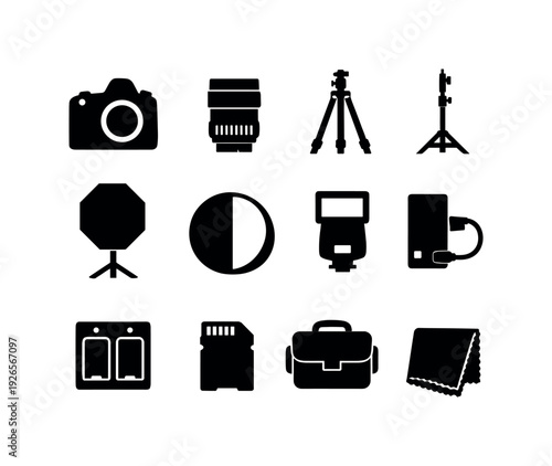 Professional photography studio gear: camera body, camera lens, tripod, light stand, softbox, reflector panel, flash unit, battery pack, charger